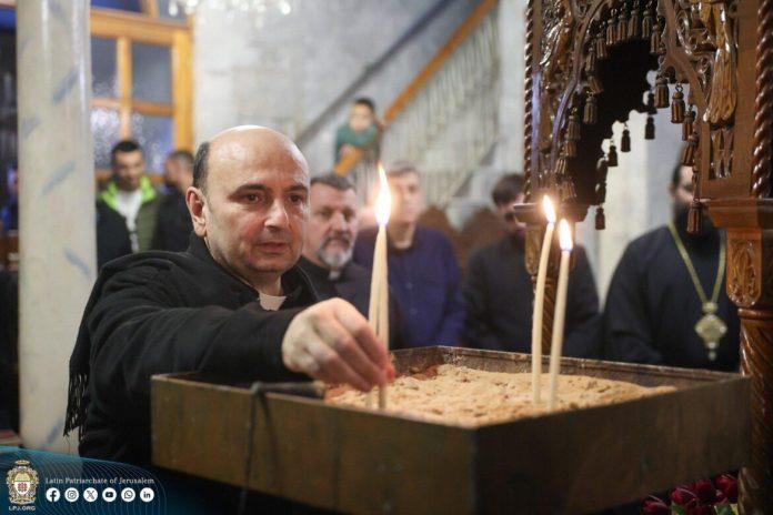 Father Gabriel Romanelli, pastor of Holy Family Church in Gaza City, lights a candle Dec. 22, 2024. In a video posted on his X account April 6, 2026, Father Romanelli said on Easter, he received a message from Pope Leo XIV who "has been constantly in contact with us, through messages and at times, through phone calls." (OSV News photo/courtesy Latin Patriarchate of Jerusalem)