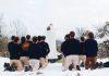 Pope Urges Catholic Communities to Reignite Youth Faith Amid Rising “Spiritual Poverty” Youth at a mass on a snow capped mountian (Photo by Maël BALLAND on Unsplash)
