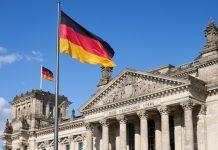 Catholic Church Launches “Vote Consciously” Campaign as Far-Right Surges in Saxony-Anhalt Close-up Deutscher Reichstag with german national flags (Photo by Norbert Braun on Unsplash)