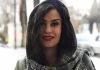 Iran Arrests Prominent Christian Lawyer Amid Escalating Crackdown on Dissent and Religious Minorities Woman with dark hair and red lipstick smiling at the camera on a city street.