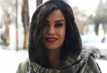 Iran Arrests Prominent Christian Lawyer Amid Escalating Crackdown on Dissent and Religious Minorities Woman with dark hair and red lipstick smiling at the camera on a city street.