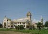 Cathedral’s Return Signals Fragile Hope Amid Myanmar’s Displacement Crisis Large ornate church with white and gold exterior, arched windows, and a tall bell tower under a clear blue sky.